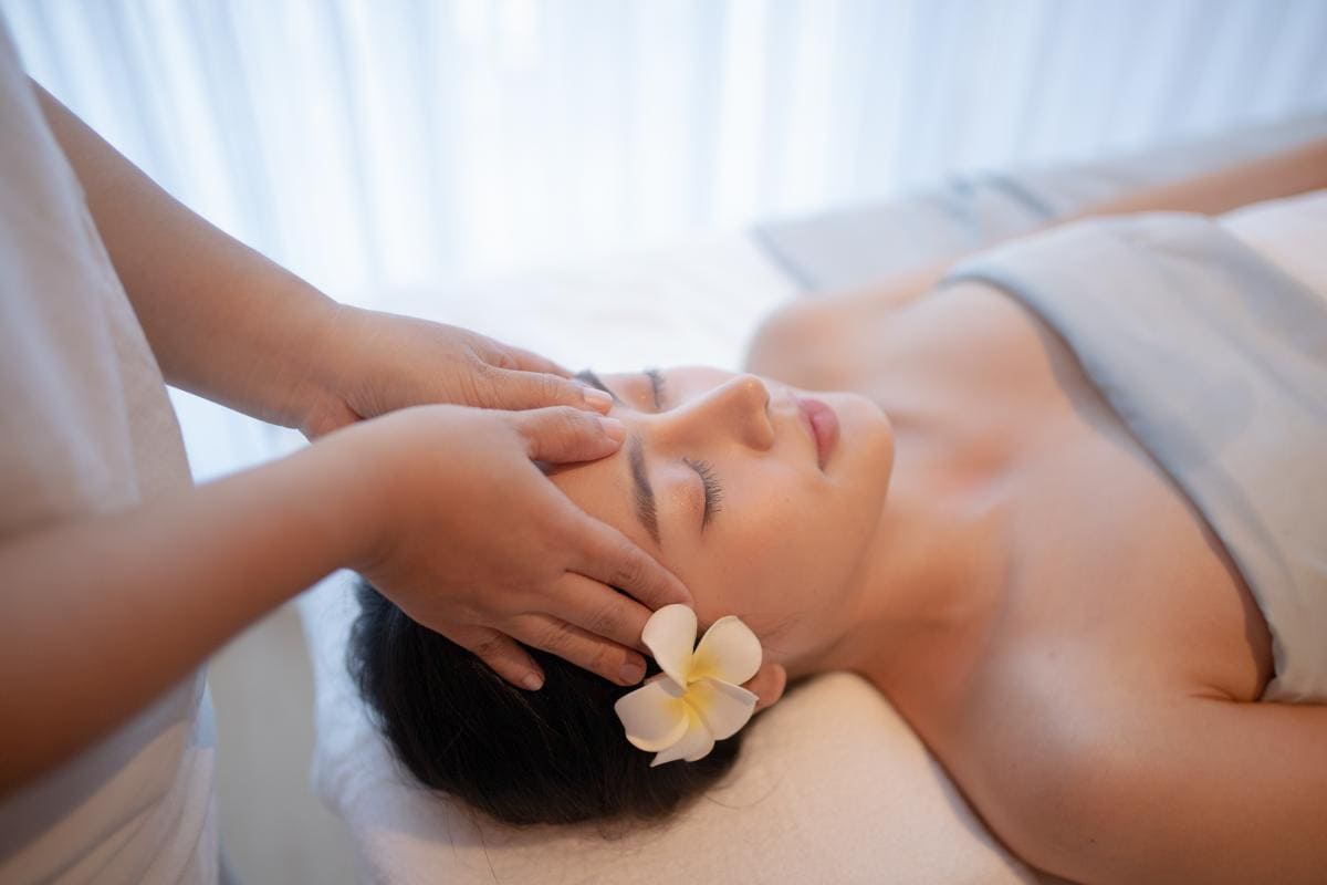 A woman enjoying a 4-hands Indian head massage