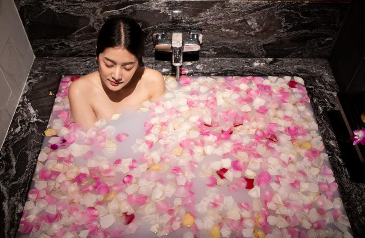 A woman enjoying a milky bath spa at Makkha Health & Spa