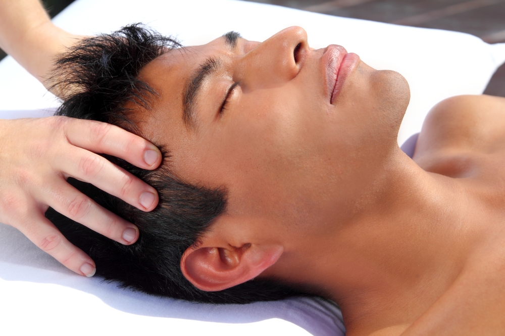 Alt text: A man getting an Indian head massage