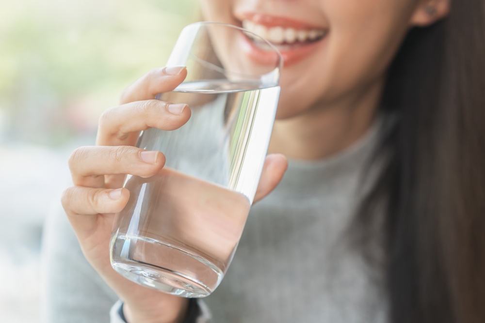 A woman drinking water after a massage