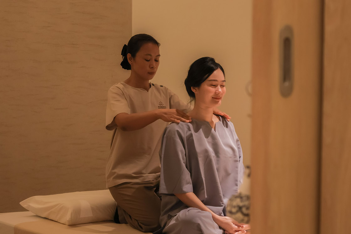 A woman receiving a back, neck and shoulder massage service