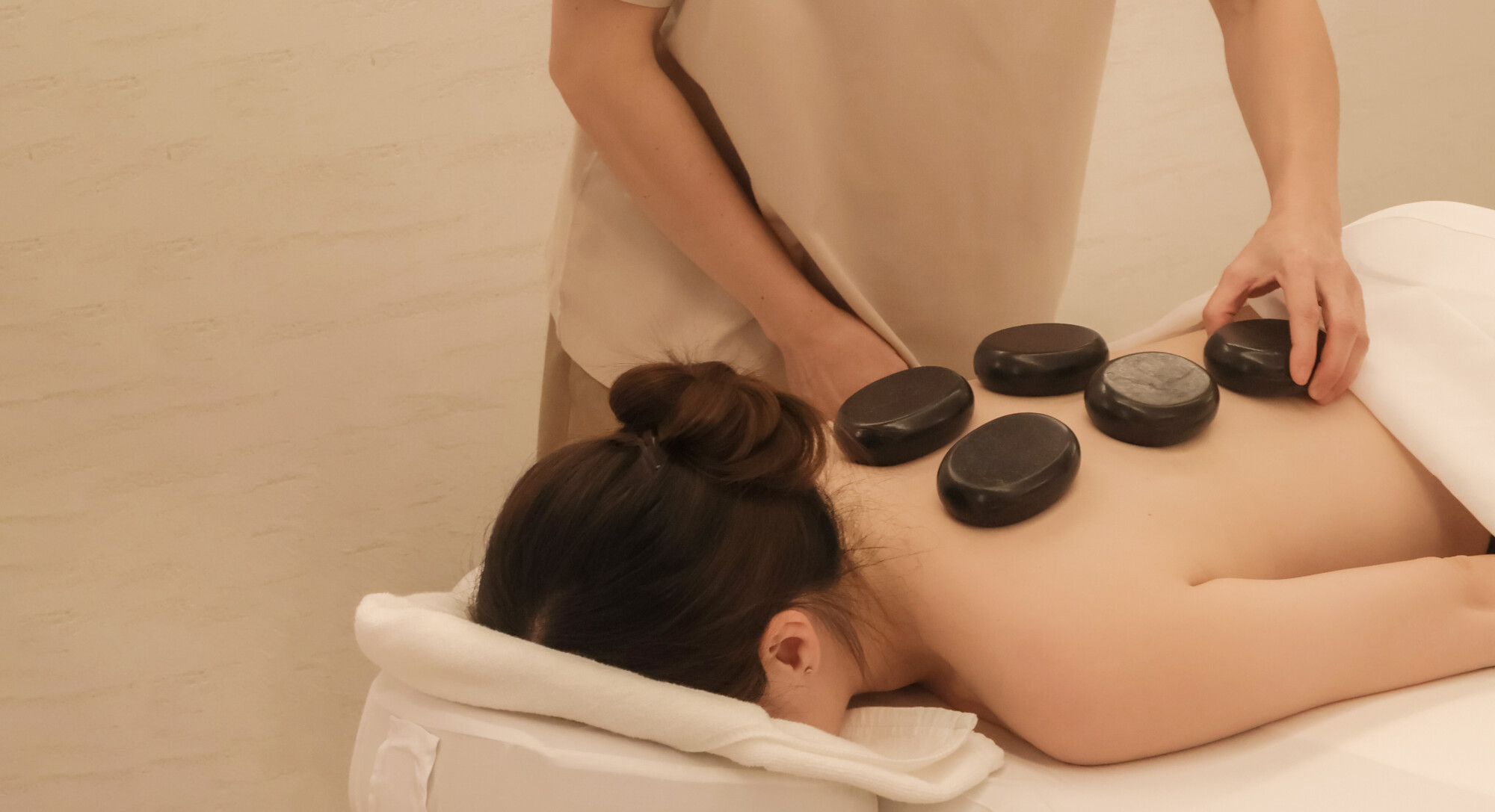 A woman getting a hot stone massage