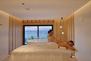 Relaxing massage session at Makkha Spa in Chiangmai with a scenic view through large windows.