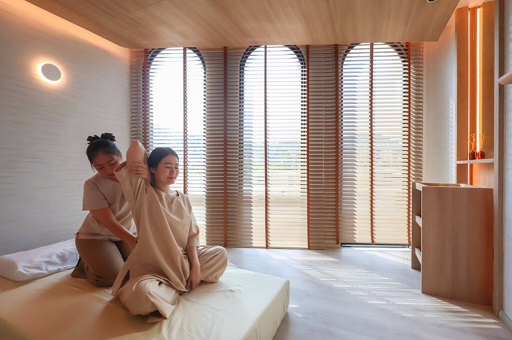 Relaxing massage session at Makkha Spa in Chiangmai, featuring a serene and modern interior with natural light, wooden accents, and a calming atmosphere for ultimate wellness and relaxation.