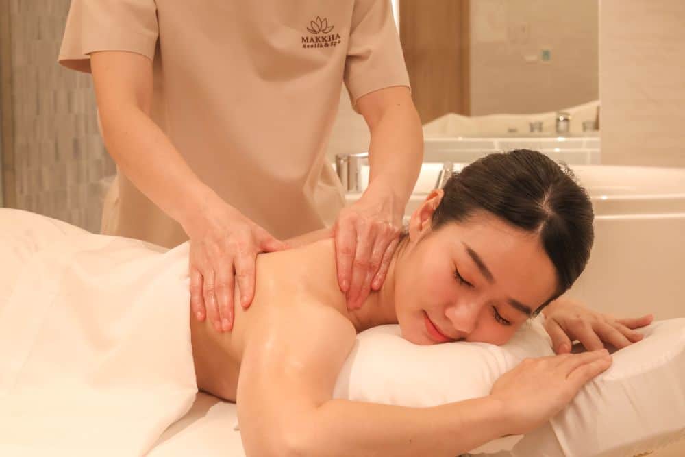 A woman enjoying her massage session at Makkha Health & Spa before her workout.