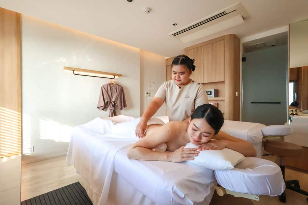 A tired traveler receiving a Thai massage that helps reset the body clock after a long flight.