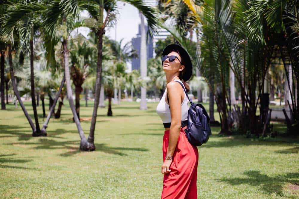 A woman takes in a garden view during a relaxing 2-day itinerary in Bangkok, away from city traffic.