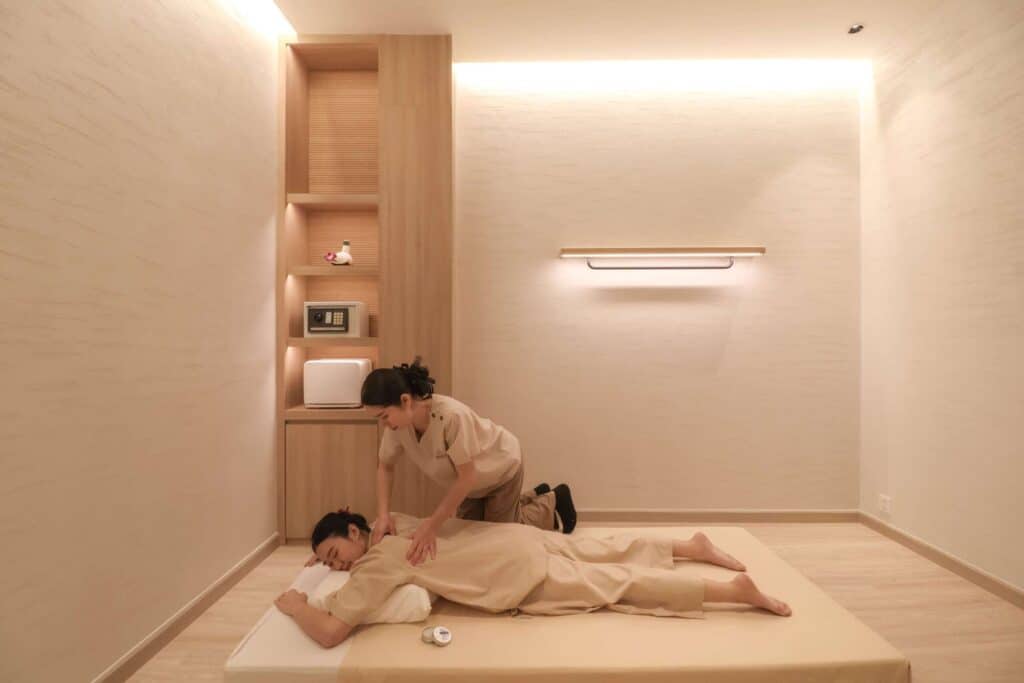 A calm private treatment room during a Bangkok wellness itinerary, set up for Thai balm massage at Makkha Health & Spa