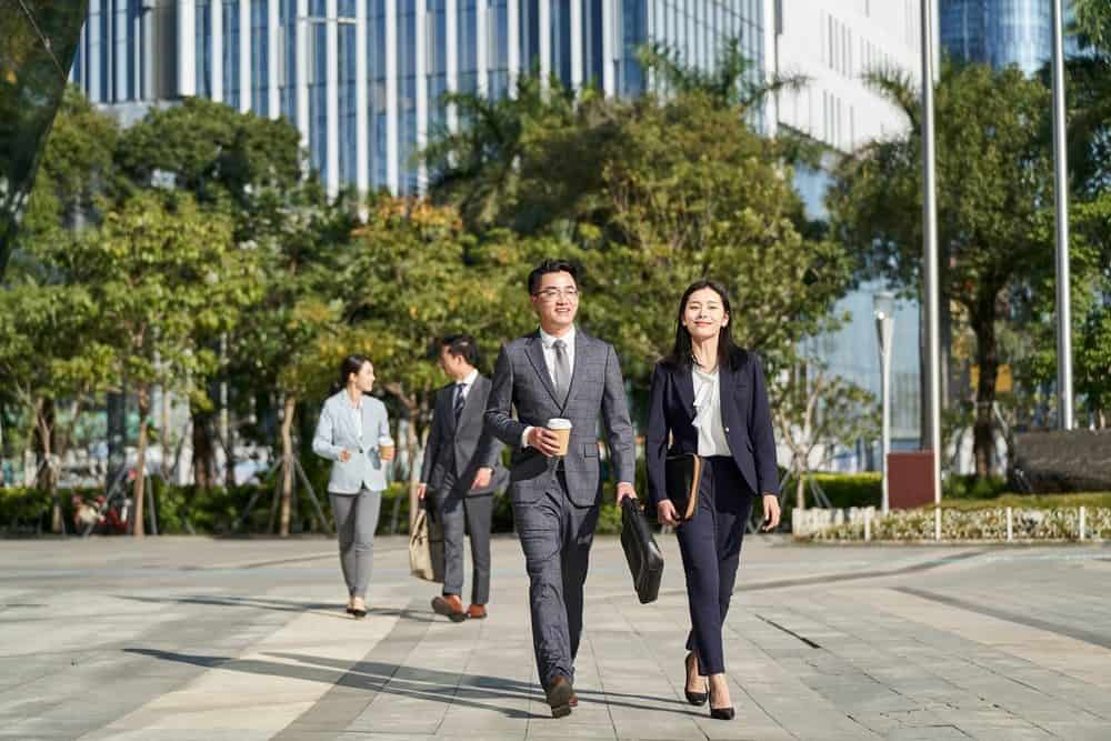 Professionals walking through Sukhumvit after work looking for things to do