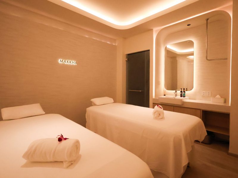 Relaxing spa treatment room at Makkha Spa in Chiangmai with two massage beds, soft lighting, and a modern, tranquil ambiance for ultimate relaxation.