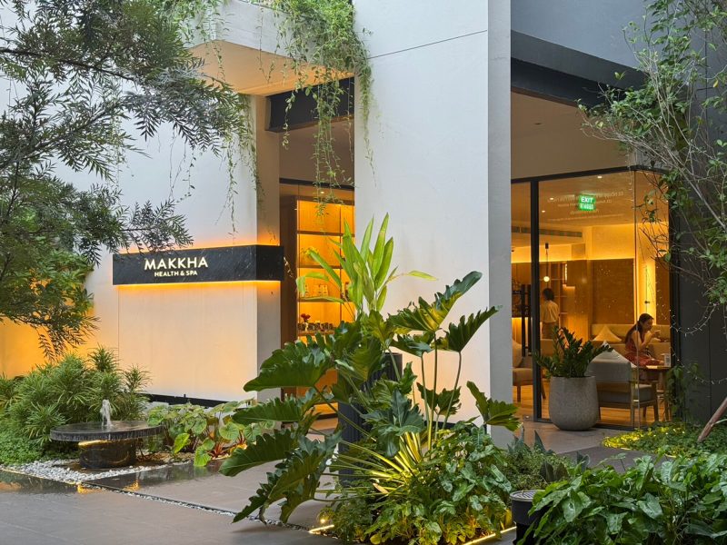 Luxury modern spa entrance with lush greenery and warm lighting at Makkha Health and Spa in Chiangmai.
